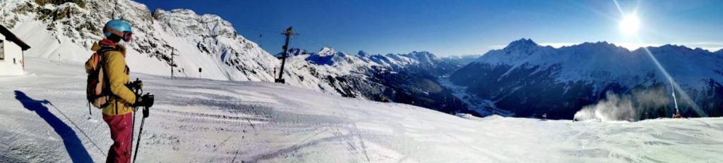 A-Z ski school instructor appreciates a panoramic view of the mountains after ski touring
