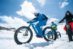 3 people fat-biking over snow